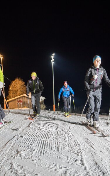 Going on an evening ski tour on the illuminated piste